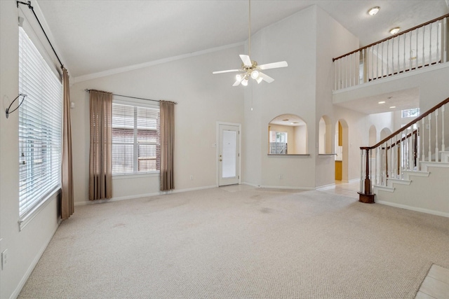 5111 Maple Hill Trl, Houston, TX 77345 - unfurnished living room featuring carpet flooring, a ceiling fan, arched walkways, stairs, and high vaulted ceiling
