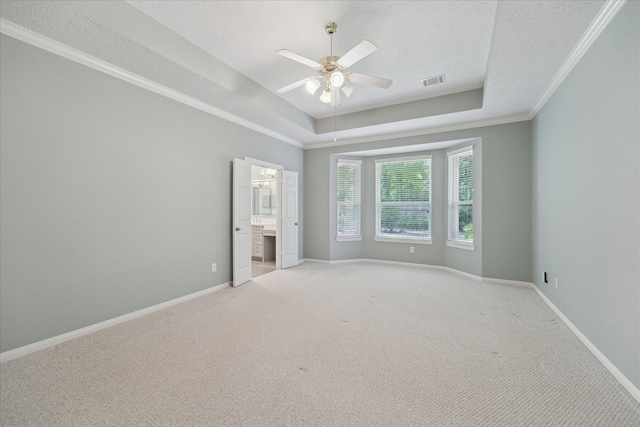 5111 Maple Hill Trl, Houston, TX 77345 - unfurnished bedroom featuring a raised ceiling, light colored carpet, baseboards, crown molding, and a textured ceiling