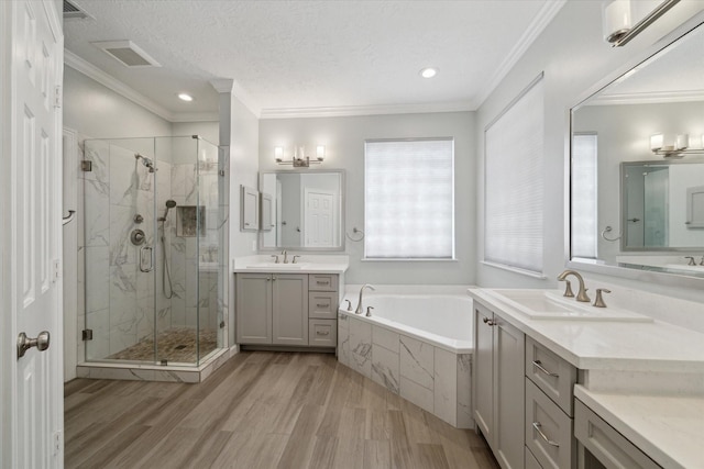 5111 Maple Hill Trl, Houston, TX 77345 - bathroom with a bath, a marble finish shower, wood finished floors, ornamental molding, and two vanities