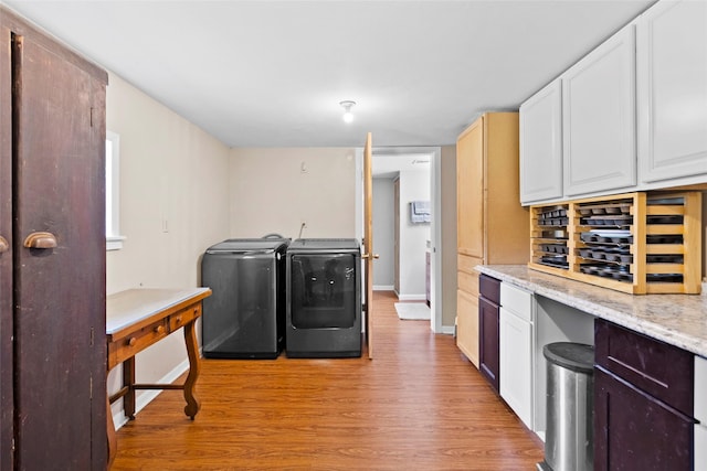 4420 Shady Ln, Huntsville, TX 77320 - laundry room with washer and dryer, baseboards, and light wood finished floors
