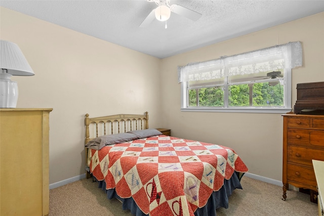 4420 Shady Ln, Huntsville, TX 77320 - bedroom with carpet floors, a textured ceiling, baseboards, and ceiling fan