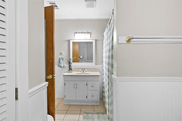 4420 Shady Ln, Huntsville, TX 77320 - bathroom with tile patterned flooring, a wainscoted wall, and vanity