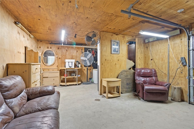 4420 Shady Ln, Huntsville, TX 77320 - living room with unfinished concrete floors, wooden walls, and wood ceiling
