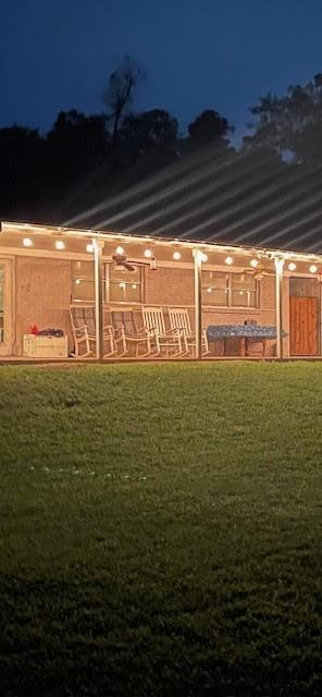 4420 Shady Ln, Huntsville, TX 77320 - yard at twilight featuring a lawn