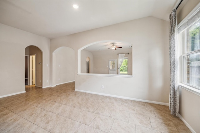 5332 Pointe Spring Xing, Spring, TX 77389 - unfurnished room with plenty of natural light, a ceiling fan, tile patterned flooring, arched walkways, and vaulted ceiling