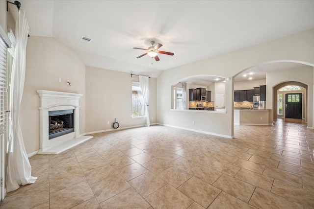 5332 Pointe Spring Xing, Spring, TX 77389 - unfurnished living room featuring a ceiling fan, a fireplace with raised hearth, and baseboards