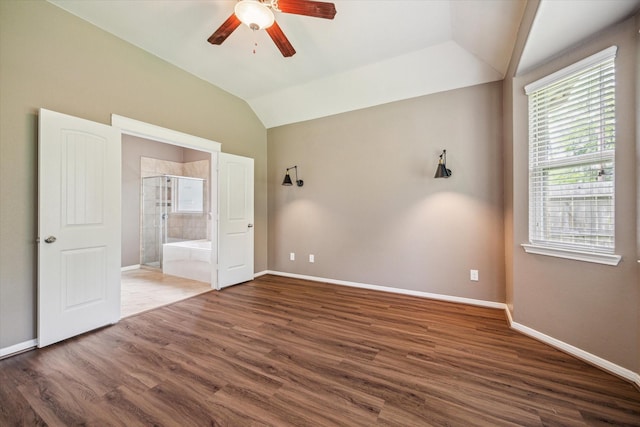 5332 Pointe Spring Xing, Spring, TX 77389 - unfurnished bedroom with multiple windows, vaulted ceiling, baseboards, and wood finished floors