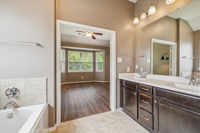 5332 Pointe Spring Xing, Spring, TX 77389 - bathroom featuring a ceiling fan, tile patterned flooring, a bath, double vanity, and baseboards