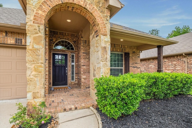 5332 Pointe Spring Xing, Spring, TX 77389 - property entrance featuring brick siding, a shingled roof, an attached garage, and stone siding