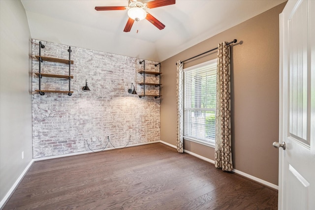 5332 Pointe Spring Xing, Spring, TX 77389 - spare room with baseboards, wood finished floors, ceiling fan, vaulted ceiling, and brick wall