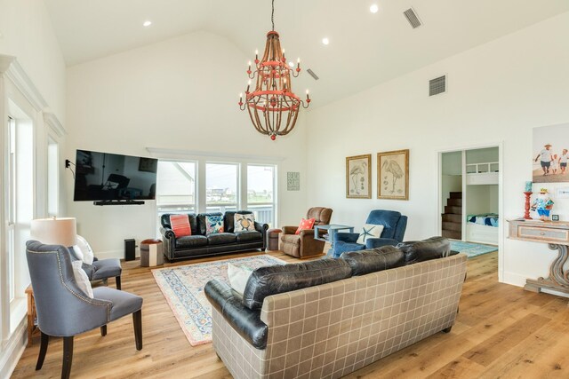 998 Austin Dr, Gilchrist, TX 77617 - living area with high vaulted ceiling, a chandelier, light wood finished floors, and recessed lighting