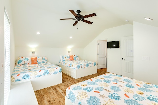 998 Austin Dr, Gilchrist, TX 77617 - bedroom with light wood-type flooring, lofted ceiling, multiple windows, and a ceiling fan