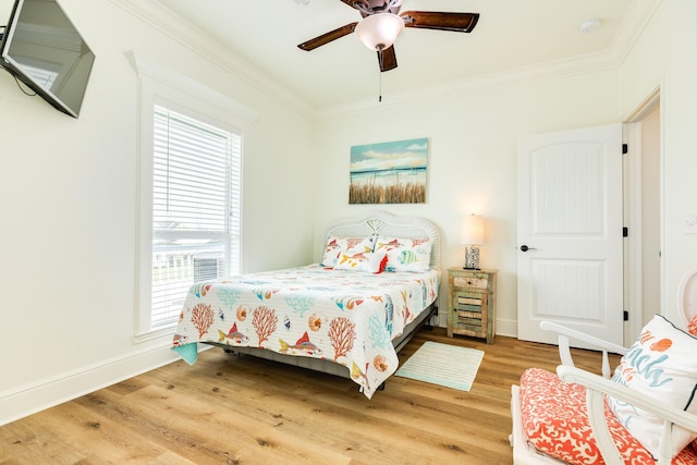 998 Austin Dr, Gilchrist, TX 77617 - bedroom featuring multiple windows, light wood-style floors, crown molding, baseboards, and ceiling fan