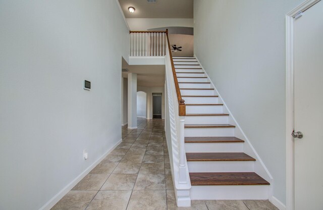 14814 Bridle Bend Dr, Houston, TX 77084 - staircase featuring arched walkways, baseboards, and a high ceiling