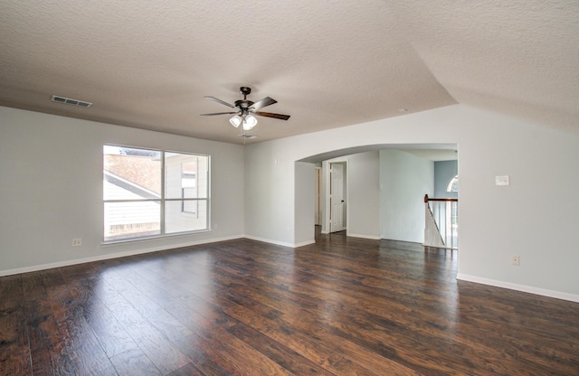 14814 Bridle Bend Dr, Houston, TX 77084 - spare room with ceiling fan, arched walkways, dark wood finished floors, a textured ceiling, and baseboards