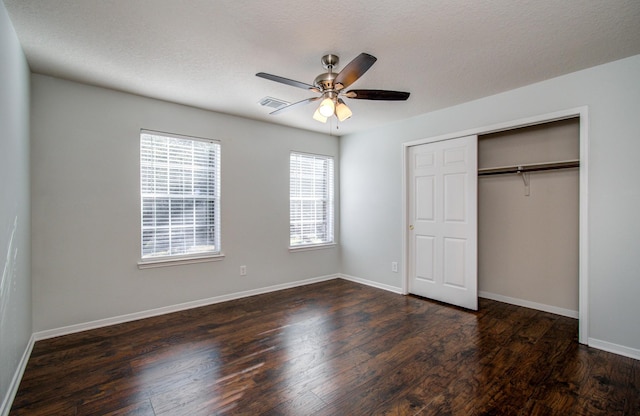 14814 Bridle Bend Dr, Houston, TX 77084 - unfurnished bedroom featuring dark wood-type flooring, baseboards, a closet, and a ceiling fan