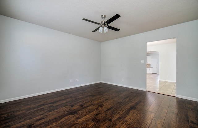 14814 Bridle Bend Dr, Houston, TX 77084 - spare room featuring a ceiling fan, arched walkways, wood finished floors, and baseboards