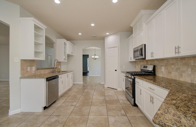 14814 Bridle Bend Dr, Houston, TX 77084 - kitchen with appliances with stainless steel finishes, a sink, backsplash, recessed lighting, and stone counters
