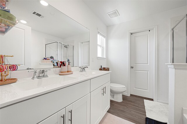 17723 Seed Drill Ln, Hockley, TX 77447 - full bath with a shower stall, double vanity, toilet, and wood finished floors