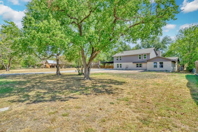 1021 S State St, Madisonville, TX 77864 - view of grassy yard featuring an attached carport