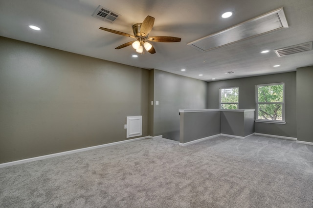 1021 S State St, Madisonville, TX 77864 - spare room with attic access, carpet flooring, recessed lighting, a ceiling fan, and baseboards