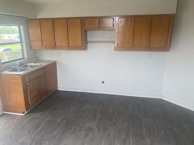 3015 Ohio St, Fresno, TX 77545 - kitchen with a sink, dark wood-style flooring, and brown cabinetry