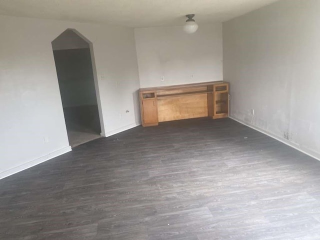 3015 Ohio St, Fresno, TX 77545 - unfurnished living room featuring dark wood-style flooring and baseboards