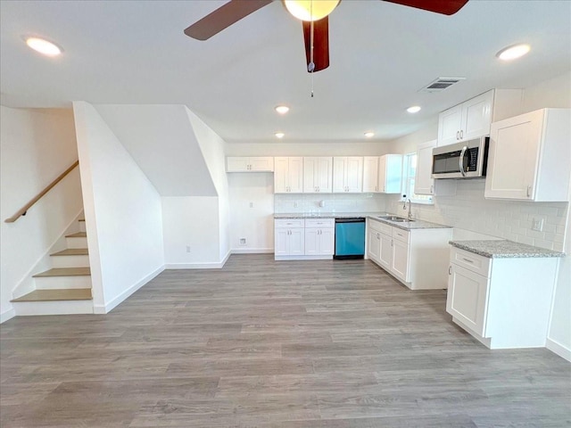 6309 Sandra St, Houston, TX 77028 - kitchen featuring a sink, dishwasher, stainless steel microwave, a ceiling fan, and baseboards