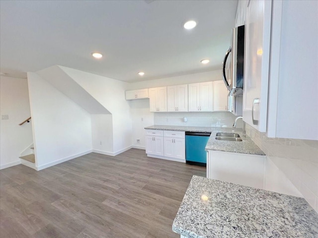 6309 Sandra St, Houston, TX 77028 - kitchen with dishwasher, a sink, white cabinets, light stone counters, and stainless steel microwave