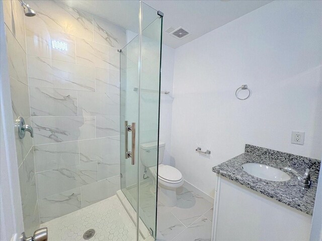 6309 Sandra St, Houston, TX 77028 - full bath with marble finish floors, toilet, a stall shower, vanity, and baseboards