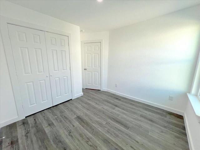 6309 Sandra St, Houston, TX 77028 - unfurnished bedroom featuring wood finished floors, a closet, and baseboards