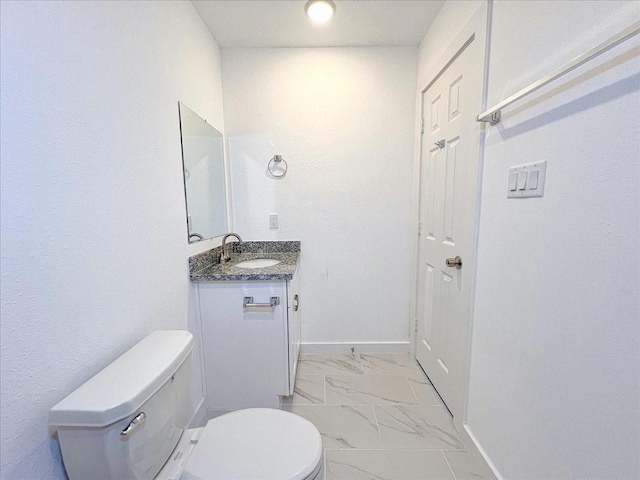 6309 Sandra St, Houston, TX 77028 - bathroom featuring toilet, marble look tile flooring, vanity, and baseboards