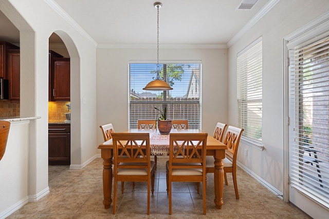 4307 Countrypines Dr, Spring, TX 77388 - dining space with ornamental molding, arched walkways, light tile patterned floors, and baseboards