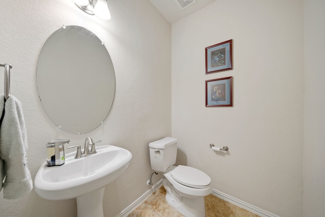 4307 Countrypines Dr, Spring, TX 77388 - half bathroom featuring baseboards, toilet, a sink, and tile patterned floors