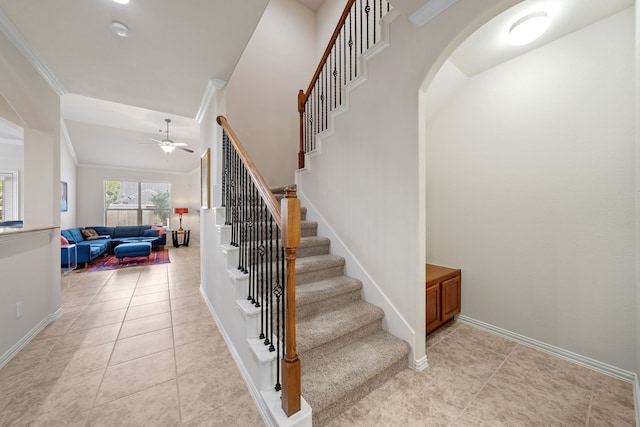 4307 Countrypines Dr, Spring, TX 77388 - staircase featuring a ceiling fan, arched walkways, baseboards, tile patterned floors, and ornamental molding
