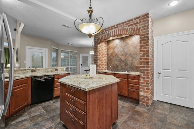 19634 Stone Lake Dr, Tomball, TX 77377 - kitchen with black dishwasher, stainless steel gas stovetop, a kitchen island, hanging light fixtures, and light stone countertops