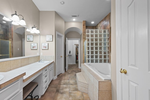 19634 Stone Lake Dr, Tomball, TX 77377 - bathroom featuring tiled shower, double vanity, a bath, a closet, and recessed lighting