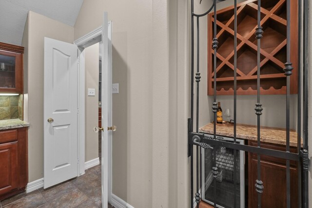 19634 Stone Lake Dr, Tomball, TX 77377 - wine cellar featuring wine cooler and baseboards