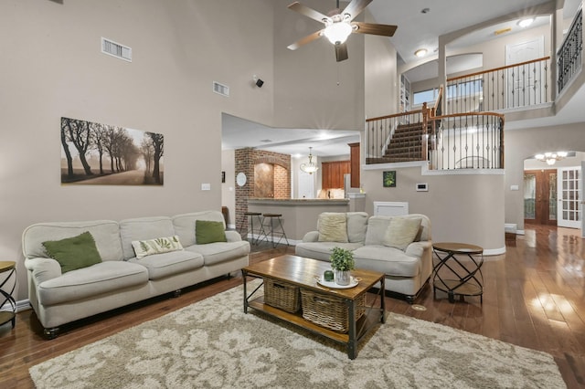 19634 Stone Lake Dr, Tomball, TX 77377 - living room with a high ceiling, baseboards, wood-type flooring, ceiling fan, and a chandelier