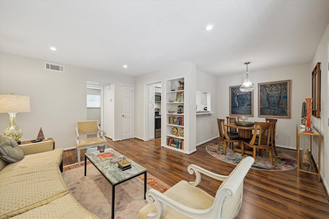 606 Marshall St Unit C2, Houston, TX 77006 - living area featuring wood finished floors, baseboards, built in shelves, and recessed lighting