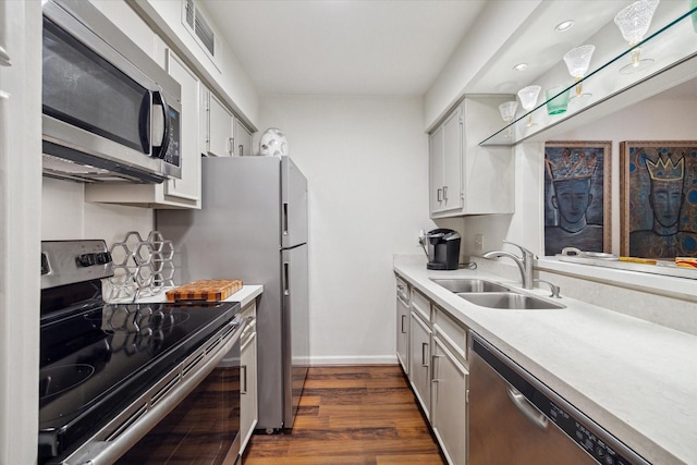 606 Marshall St Unit C2, Houston, TX 77006 - kitchen with appliances with stainless steel finishes, a sink, baseboards, light countertops, and dark wood-style flooring