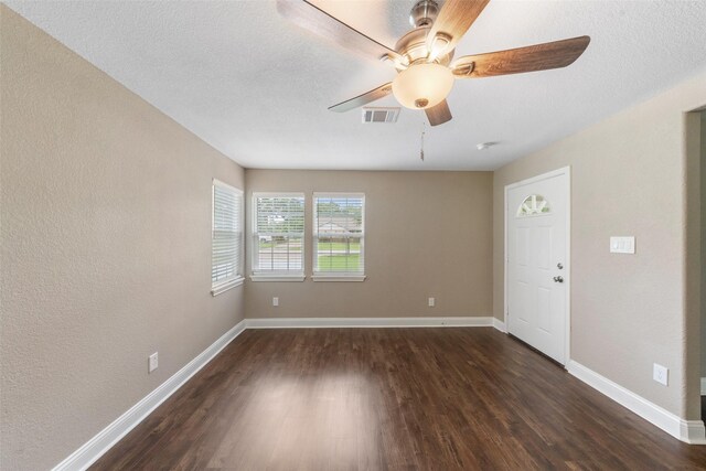 5117 Winding Way, Dickinson, TX 77539 - empty room with dark wood-style flooring, baseboards, a ceiling fan, and a textured wall