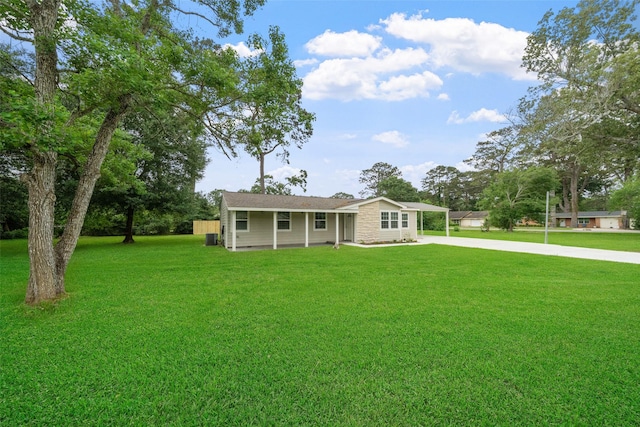 5117 Winding Way, Dickinson, TX 77539 - ranch-style house featuring a carport, concrete driveway, and a front yard