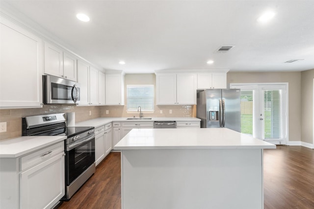 5117 Winding Way, Dickinson, TX 77539 - kitchen featuring appliances with stainless steel finishes, a sink, a kitchen island, dark wood finished floors, and recessed lighting