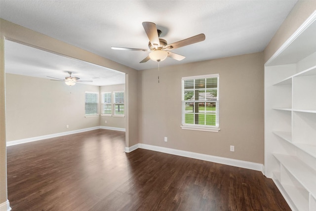 5117 Winding Way, Dickinson, TX 77539 - empty room featuring ceiling fan, dark wood-style floors, and baseboards