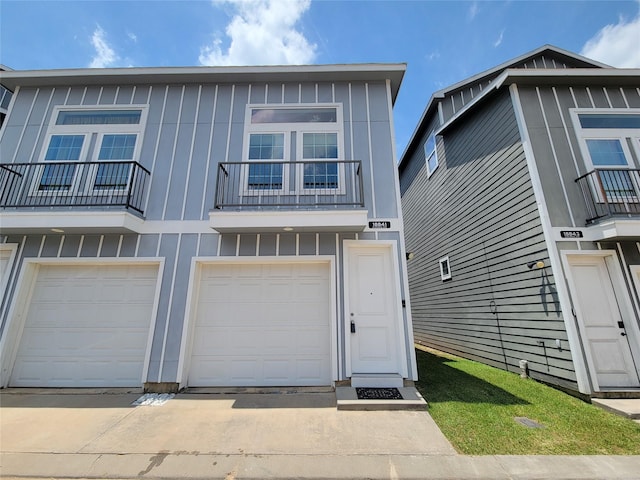 18841 Elegance Ave, Spring, TX 77379 - view of property featuring board and batten siding, an attached garage, a balcony, and driveway