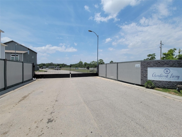 18841 Elegance Ave, Spring, TX 77379 - view of asphalt road featuring street lighting and a gate
