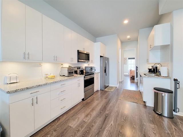 18841 Elegance Ave, Spring, TX 77379 - kitchen with stainless steel appliances, dark wood-style floors, recessed lighting, backsplash, and a sink