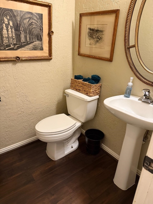 22602 Water Edge Ln, Katy, TX 77494 - half bathroom featuring toilet, wood finished floors, baseboards, and a textured wall