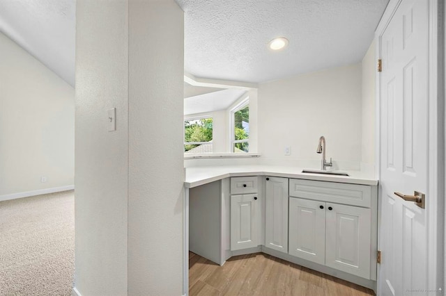 8002 Oxfordshire Dr, Spring, TX 77379 - bar with a sink, a textured ceiling, baseboards, recessed lighting, and light wood-type flooring